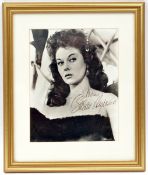 A head and shoulders studio photographic portrait signed “Susan Hayward”, mounted and framed in gilt