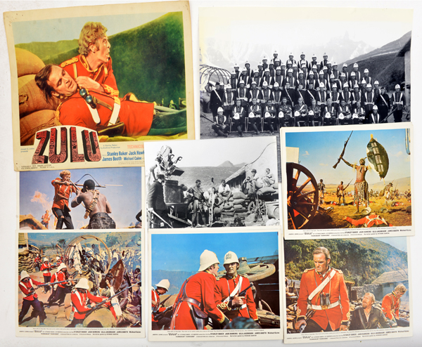 10 coloured still photographs from “Zulu”, a small poster 14” x 11” and 2 black and white photos. GC