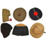 A khaki pith helmet, 2 Eastern European Cossack type astrakhan caps, a matelot cap, and 2 other