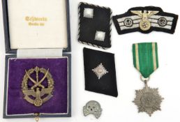 A Third Reich die struck Cossack badge; an Eastern Peoples award 2nd class with swords; SS collar