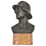 A large black painted plaster bust of a German soldier, wearing 1916 pattern steel helmet, on its