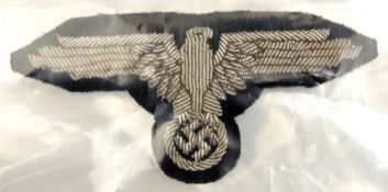 A Third Reich SS officer’s 2nd pattern silver bullion embroidered arm eagle. VGC