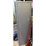 A grey painted steel gun cabinet for 4 guns, 18” x 12”x 60”, with top shelf for ammunition and 2
