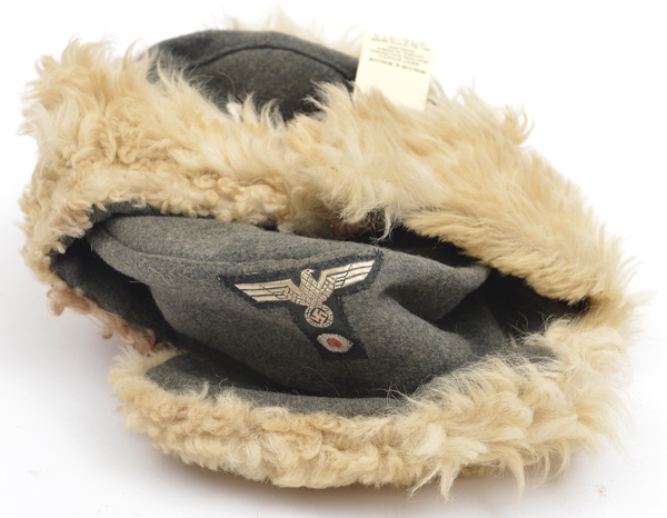 A Third Reich army winter issue cap, field grey with cap eagle and sheepskin trim. GC