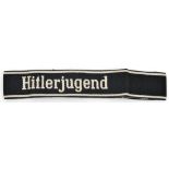 A Third Reich white on black “Hitlerjugend” woven cuffband, by Bevo. Unissued condition