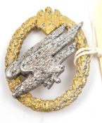 A scarce Third Reich Army Parachutist’s badge, of aluminium alloy, with gold anodised wreath and