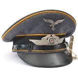 A Third Reich Luftwaffe Flight Section NCO’s peaked cap, with metal insignia, golden yellow