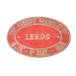 A WD locomotive brass builder’s plate. An oval locomotive plate with red painted background from