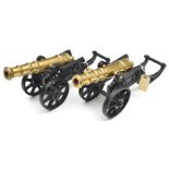 A pair of decorative modern model cannon, with 11” cast brass barrels and cast iron 2 wheeled