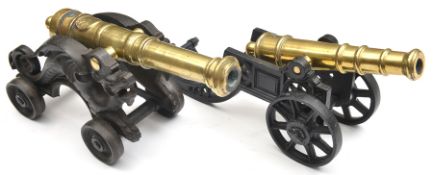 A decorative modern model cannon, with 11” cast brass barrel, on cast iron 2 wheeled carriage; and