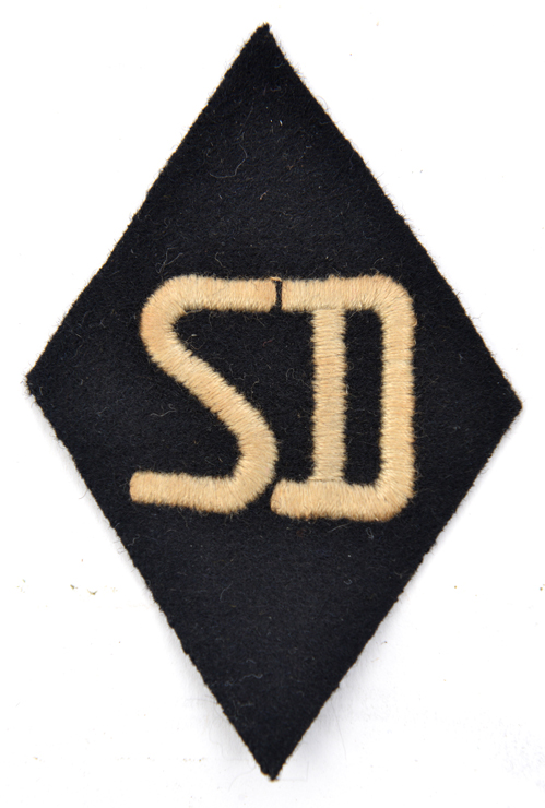 A scarce Third Reich white on black “SD” lozenge shaped sleeve patch, the back with RZM/SS paper