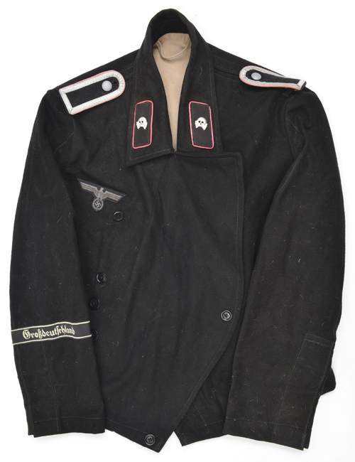 A Third Reich Panzer crew short jacket, “Grosdeutshland” cuff title, and other insignia, lining