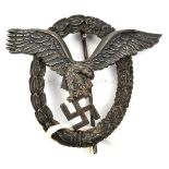 A Third Reich Pilot’s badge, of dark grey metal, the eagle with deeply impressed circle (looks