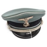 A Third Reich Waffen SS officer’s peaked SD cap, lining named to “Herr Godicke, 13 Nr 11 Den 4