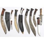 4 various kukris, 2 in sheaths; another miniature kukri; a dagger and a hunting type knife. QGC to