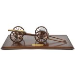 A good quality model of a British 9 pounder field gun c 1815, turned brass barrel 9”, mounted on a