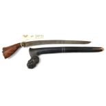 A bade bade, curved, SE blade 9”, brass band to base of traditional darkwood grips with carved