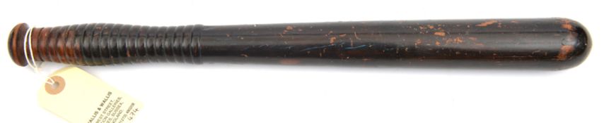 A Vic hardwood truncheon, with ribbed grip, maker’s mark on pommel of “Field Tavistock St WC”.