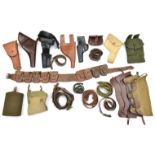 A quantity of holsters, pouches, belts, a bandolier, and similar leather and webbing equipment.