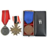 A Third Reich SS bronze 8 year service medal, with ribbon, in its box (the lid detached); an East