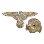 A Third Reich Waffen SS cap eagle, marked “RZM” and “M1/122” and a cap skull, marked “RZM” and “M1/