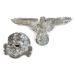 A matching pair of Third Reich Waffen SS white metal cap eagle and skull, both marked “RZM” and “