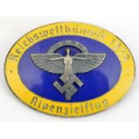 A Third Reich oval enamelled NSFK pin back badge, for “Reichsweltkampfe 1939, Alpenzielflug”, the