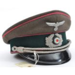 A Third Reich Panzer officer’s peaked cap, with metal eagle, bullion cockade, pink piping, dark