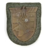 A Third Reich Krim shield, on field grey patch with paper backing. GC unissued (small patch of