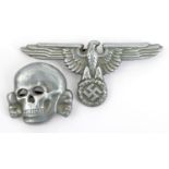 A Third Reich 1933 pattern SS aluminium alloy cap eagle, with indistinct RZM and SS marks, and an