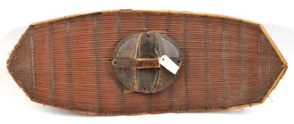 A well made Polynesian rattan shield, in fibre bound panels, panelled darkwood grip, 35” x 14” (