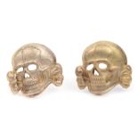 Two good quality Third Reich Waffen SS silvered cap skulls, both marked “RZM” and “M1/52”. GC