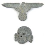 A Third Reich Waffen SS white metal cap eagle and skull pair, unmarked, with brass wire pins.
