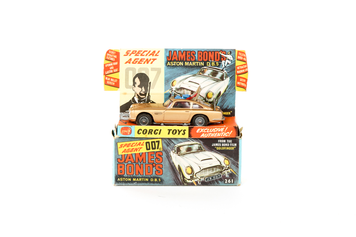 A Corgi Toys James Bond Aston Martin (261). An early example in gold with James Bond and passenger