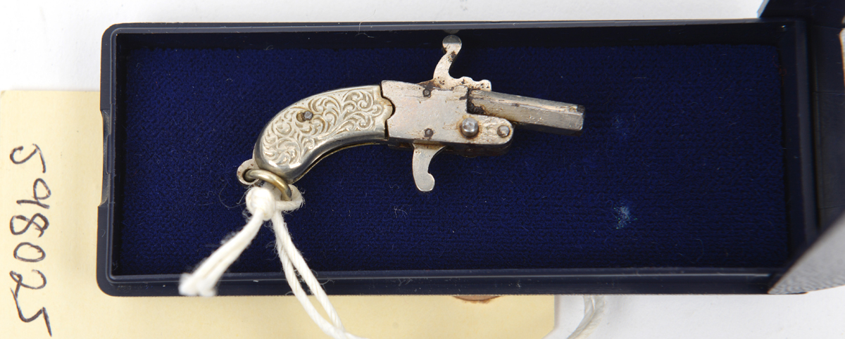 A miniature pin fire watch chain pistol c 1950s, 1½” overall, the barrel stamped “Austria”, the