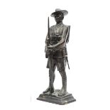 A hollow bronze figure of a Gurkha rifleman, standing easy, in full marching order, with hat,