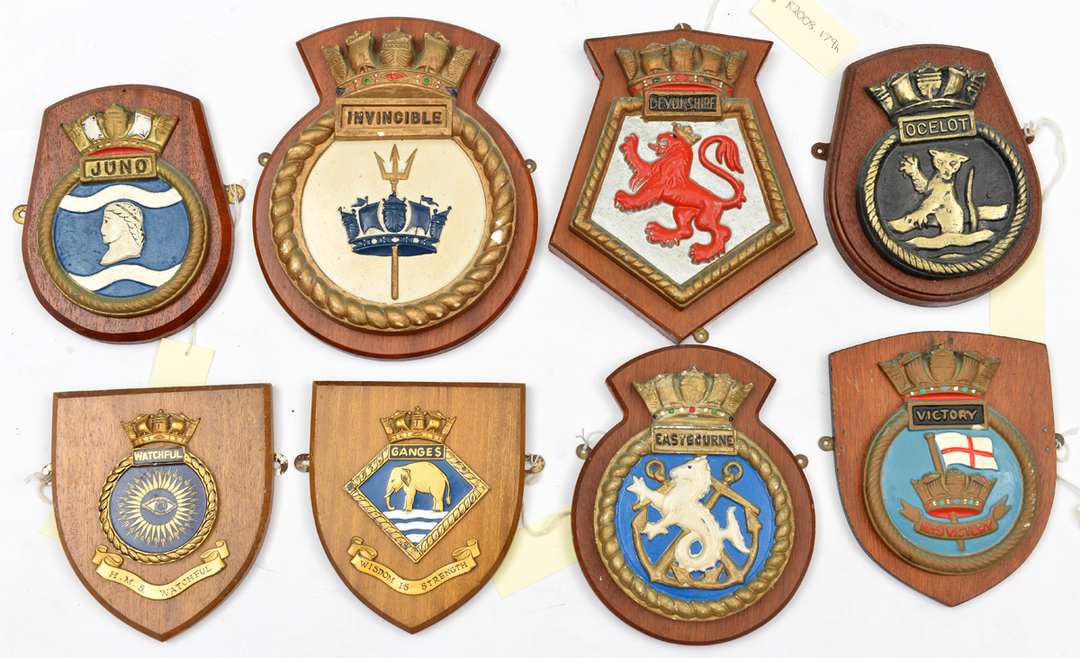 A collection of 12 ships’ plaques made of metal or plaster mounted on wooden shields: Ark Royal,