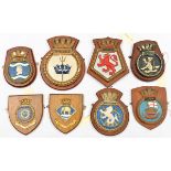 A collection of 12 ships’ plaques made of metal or plaster mounted on wooden shields: Ark Royal,