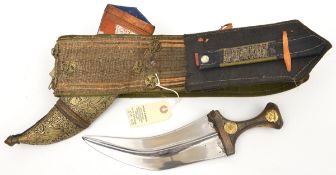 A N. African jambiya, blade 8½”, in sheath, on broad shoulder belt with embroidered panels. GC