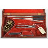 A 19th cent surgeon’s kit, comprising 2 long knives, stitching spike, slender tweezers, cutter,