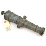 A small cast brass cannon barrel, 11” overall, with embossed “HF” monogram in circle between the