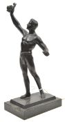 A German bronzed spelter prize statuette of a near naked athlete holding aloft a laurel wreath, on a