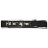 A Third Reich white on black “Hitlerjugend” woven cuffband, by Bevo. Unissued condition.