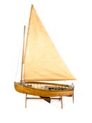 A model of a Victorian/Edwardian style sailing boat. A single masted wooden clinker built teak model