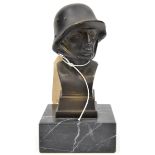 A bronzed spelter bust of a German soldier, wearing a 1916 pattern steel helmet, on rectangular