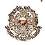 An officers silver plated headdress badge of The Border Regt, white and red enamelled centre, design