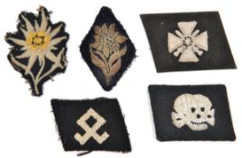 4 various Third Reich silk embroidered cloth patches: SS death’s head collar patch, Odel rune on