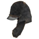 A Crimean War officer’s Balaclava helmet, of black fur with side flaps/neckguard, leather peak,