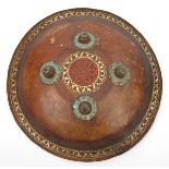 A 19th century Indian shield dhal, 4 brass bosses, decorated rim and centre circle, velvet grips and