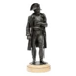 A well modelled bronzed figure of Napoleon, wearing a tricorne hat, cloak over coatee and